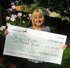 Summer Superdraw Winner receiving cheque